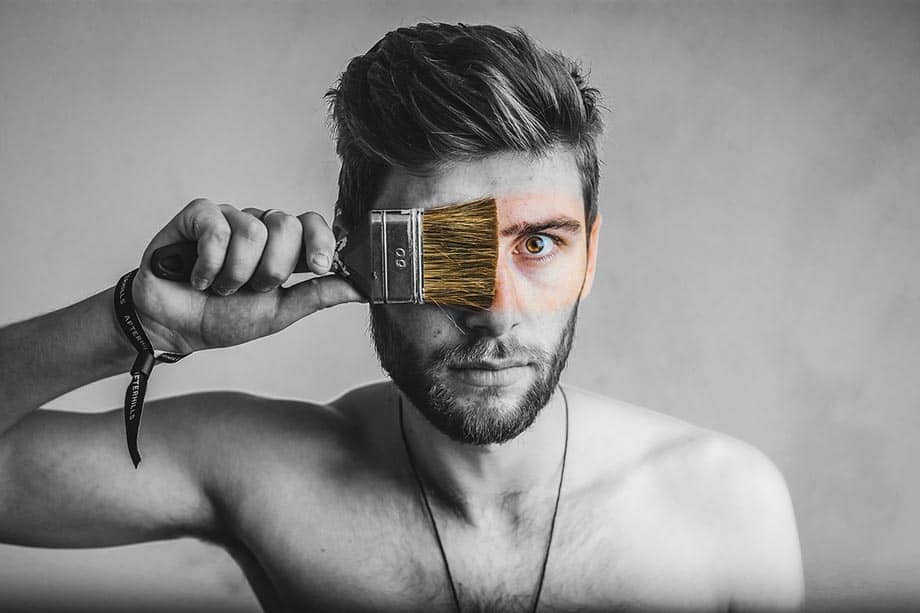 screenshot of a man with a paintbrush representing unlimited colours for themes