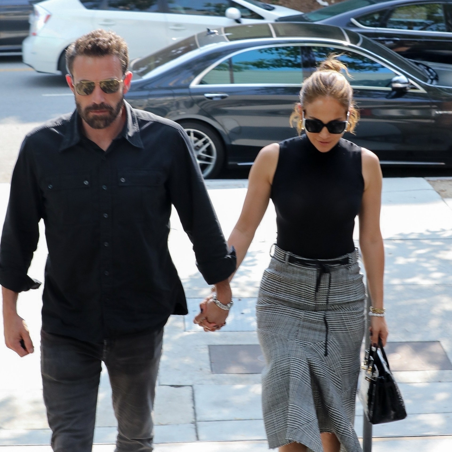 Los Angeles CA   Welldressed duo Ben Affleck and Jennifer Lopez hold hands wearing matching outfits as they go shopping...