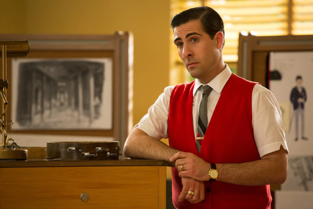 Actor Jason Schwartzman as Richard Sherman leaning against a piano in the movie "Saving Mr. Banks".