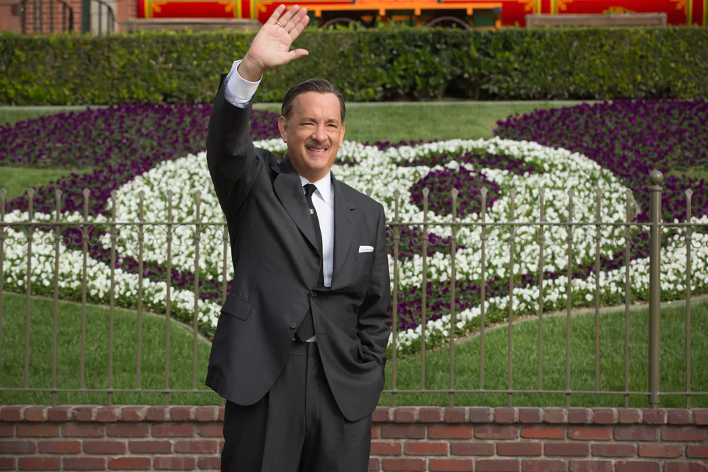 Actor Tom Hanks as Walt Disney standing and waving in front of Disneyland in the movie "Saving Mr. Banks".