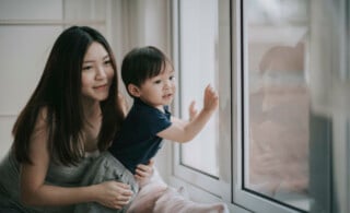 mother and son looking out window