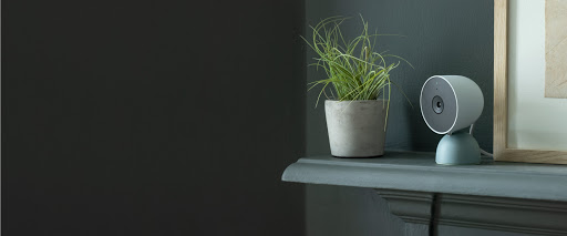 Nest Cam (wired) sits on a shelf inside a home.