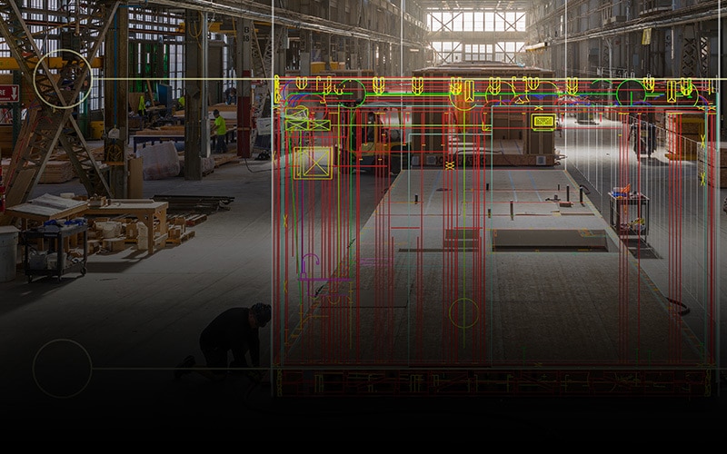 A digital design overlaid on a building under construction in the Factory_OS construction facility