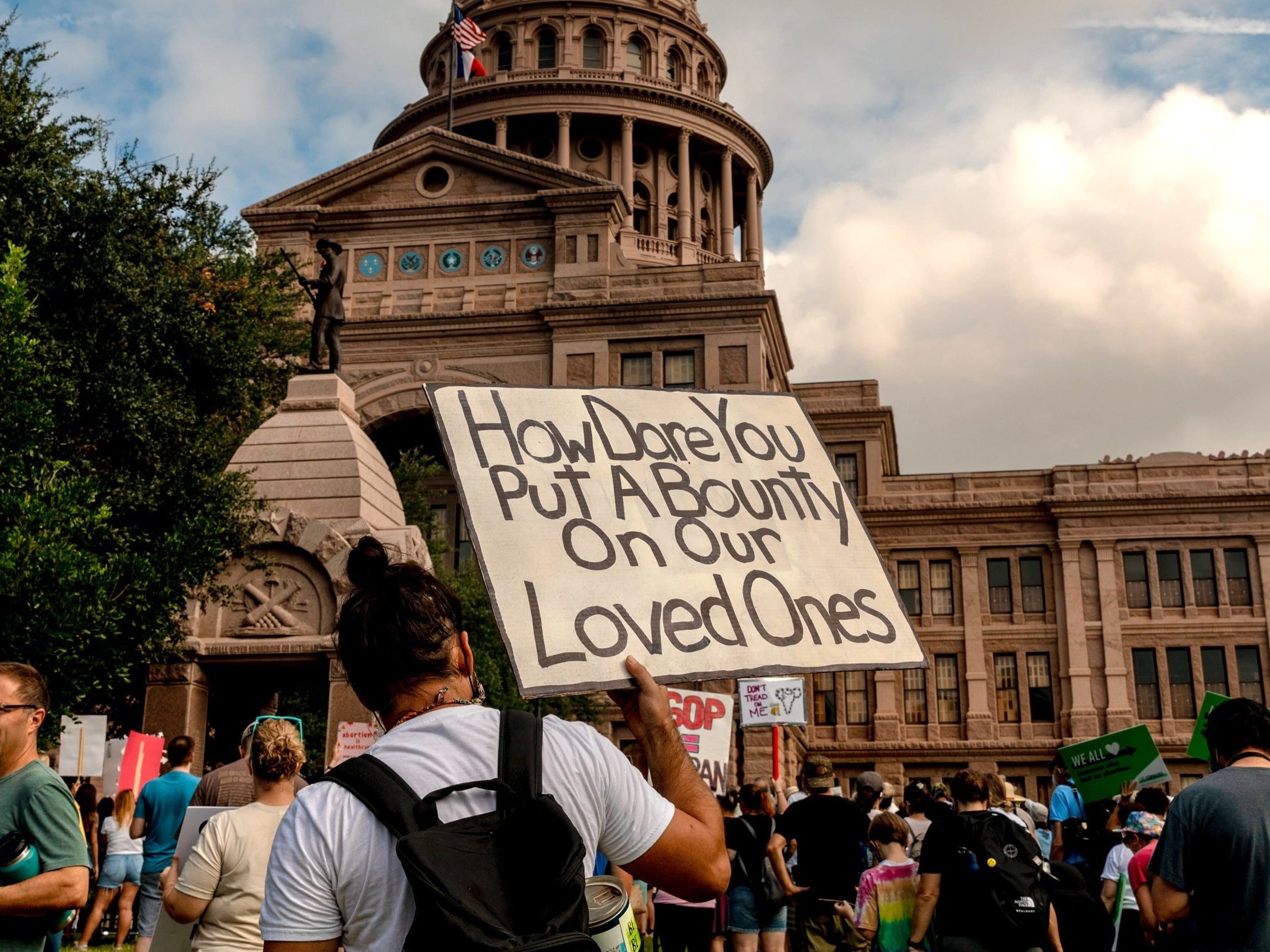 Image may contain Human Person Text Crowd and Banner