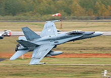 A fighter jet taking off from a runway