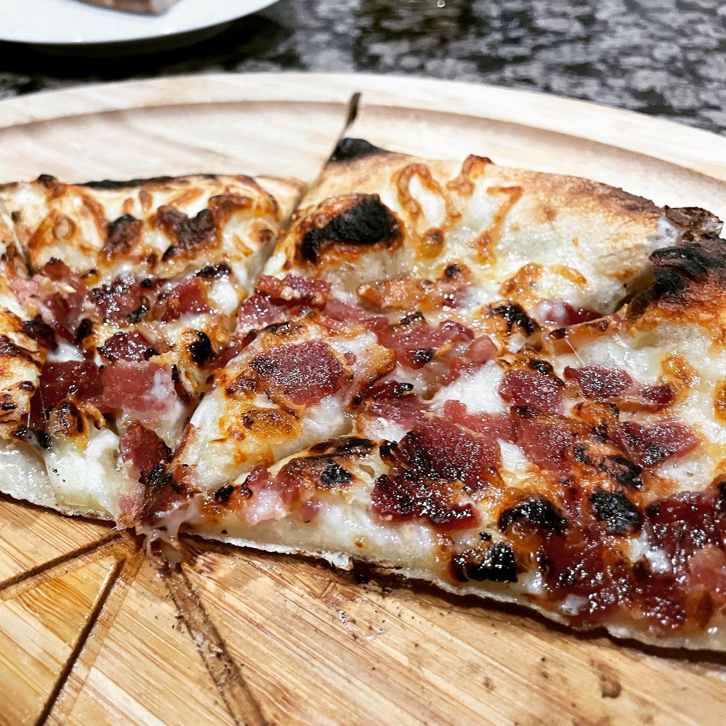 a slice of pizza sitting on top of a wooden table