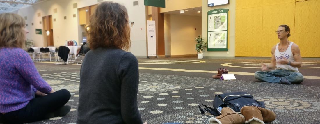 Zac sitting cross legged teaching yoga