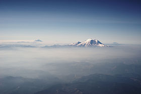 Mount Rainier and other Cascades mountains poking through clouds.jpg