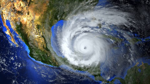 A composite image showing a hurricane approaching the U.S. Gulf Coast
