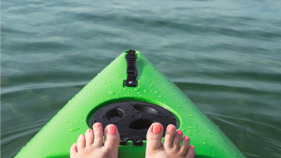 Kayak travel image of woman's feet on kayak