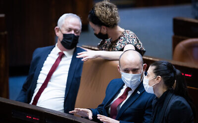 Defense Minister Benny Gantz left, Prime Minister Naftali Bennett, 2nd right, and Transportation Minister Merav Michaeli in the Knesset in Jerusalem, on July 6, 2021. (Yonatan Sindel/Flash90)