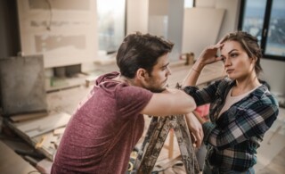 Young couple worrying about renovation of their apartment.