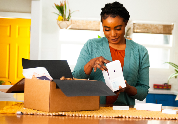 woman opening a box with beauty products inside