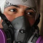 a mold removal specialist in a breathing mask. 