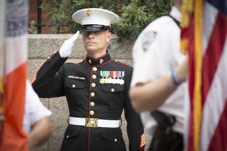 A US Marine saluting the American flag.