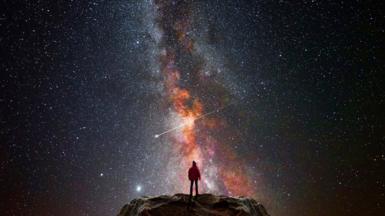 Man looking up at the night sky