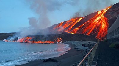 Lava flow on cliffside into ocean