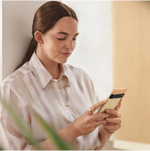 An image of a woman using her Google Pixel 6 Pro phone.
