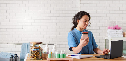 An image of a woman using a Google Pixel 6 phone to help with her pet grooming business.
