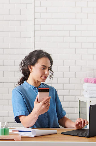 An image of a woman using a Google Pixel 6 phone to help with her pet grooming business.
