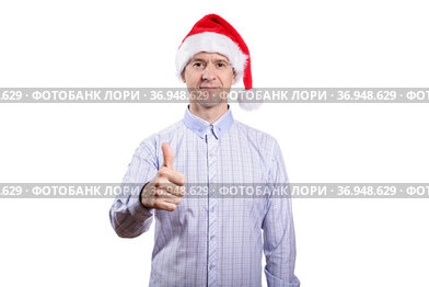 An adult confident man looks into the camera, the gesture is okay, everything is fine, dressed in everyday clothes, a light plaid shirt, a New Year's cap. Isolated, homogeneous background