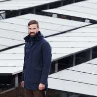 Tobias Schmidt standing in front of solar refineries