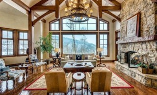 A rustic living room with a view of the Colorado mountains.