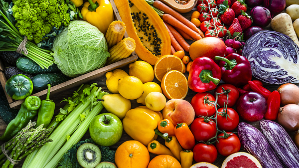 Fruits and vegetables laid out on a table, sorted by color.