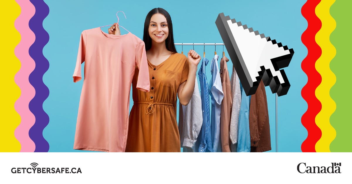 A person stands near a clothes rack holding up a pink dress.