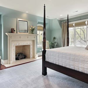 Master bedroom with stunning fireplace and four poster bed