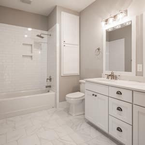 a white and beige modern bathroom with new shower/tub combo