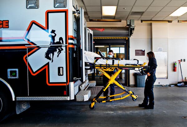 Stephanie Bartlett, left, and Cheryl Rixey pulling out a stretcher at a hospital in Sweetwater County, Wyo., for a patient transfer this month.