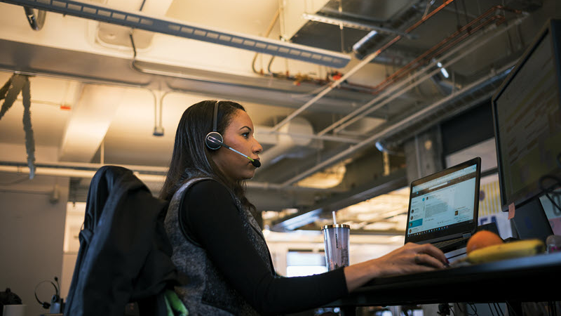 Woman at desk with headset