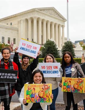 Picture of DACA students holding protest signs. 