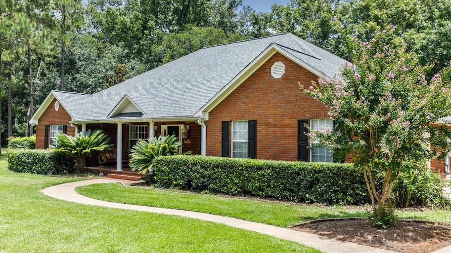 Front view of red brick house in the suburbs