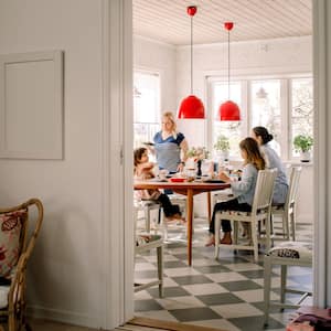 A mother having breakfast with her daughters in bright kitchen