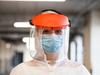 Coronavirus COVID-19 virus disease global pandemic outbreak,UK NHS frontline medical key worker,EMS Personal Protective Equipment, posing for a portrait at parking lot hallway, emergency ICU Intensive Care Unit first responder