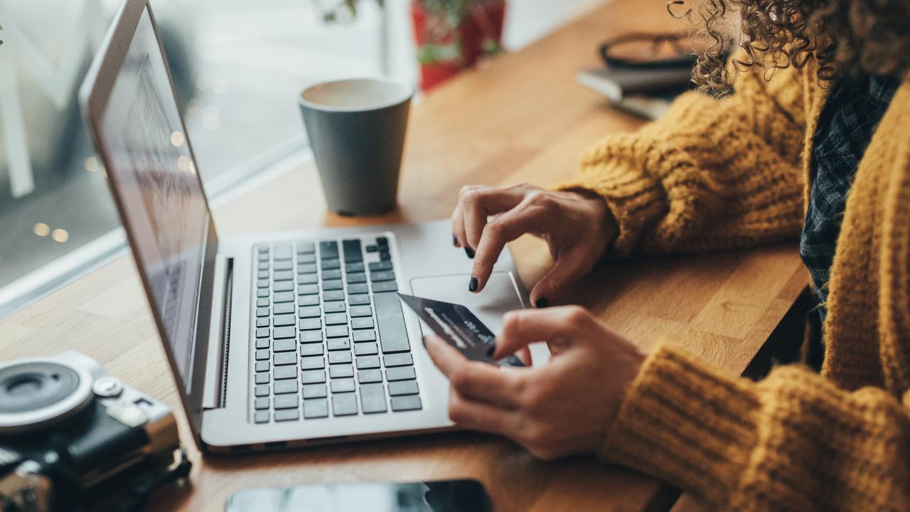 Woman in cafe shopping online with laptop