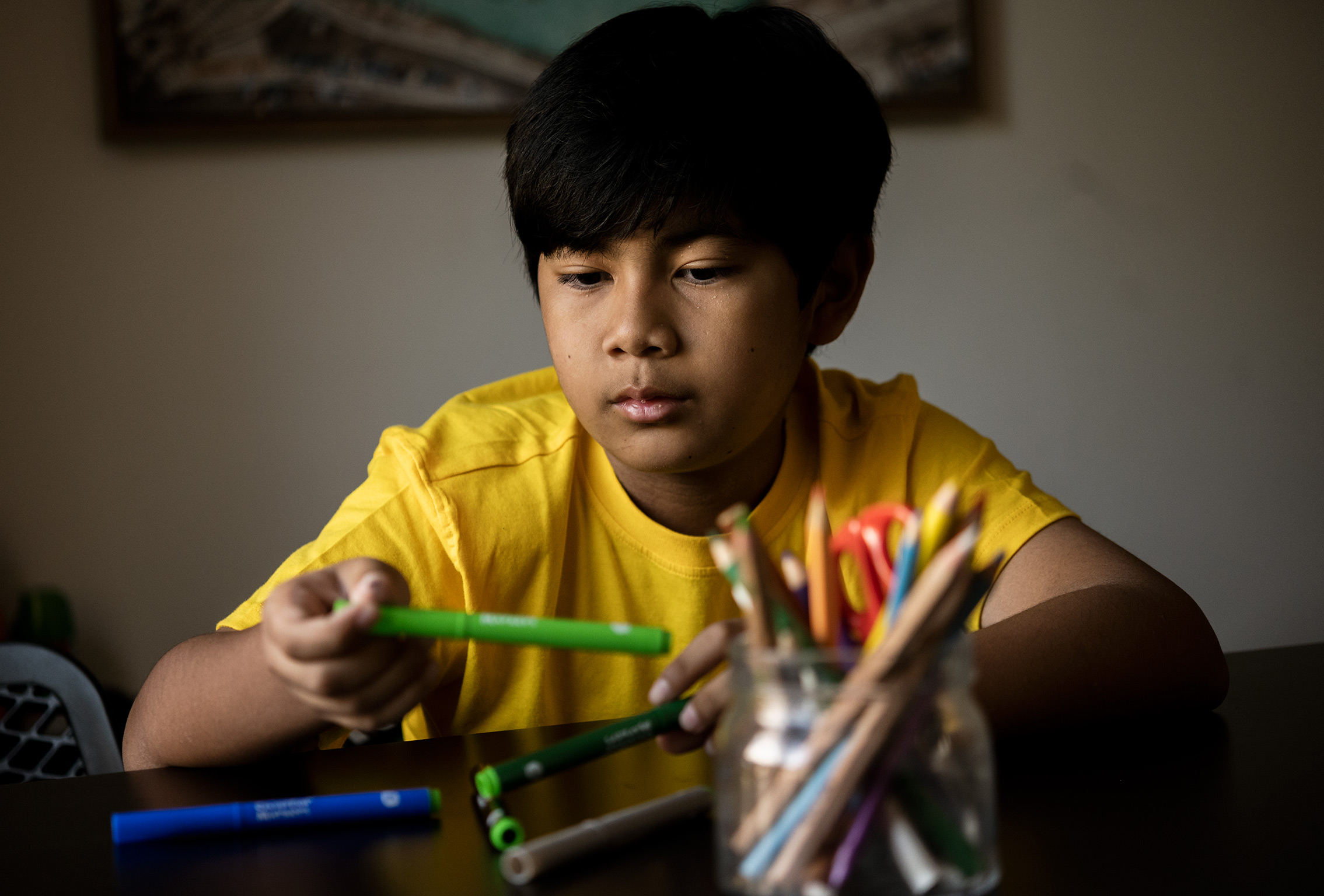 Young boy in yellow playing with craft at the Quirky Kid clinic child psychologist Sydney