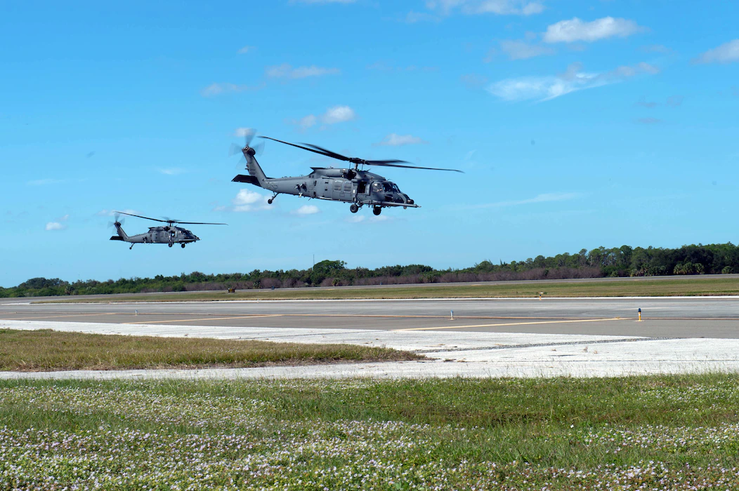 Two HH-60W Jolly Green IIs take off