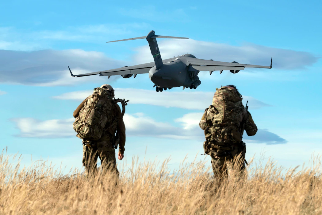 Special tactics operators observe as a C-17 Globemaster III takes off