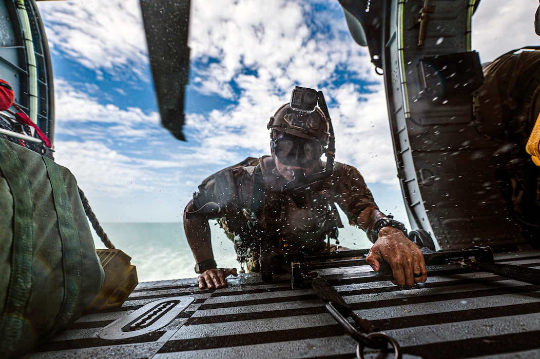 A pararescueman, climbs into an HH-60W