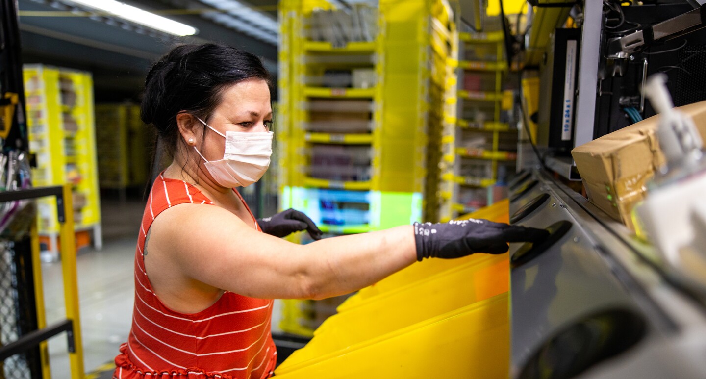 Amazon associate wears a mask while working. Photo taken during the COVID-19 pandemic.