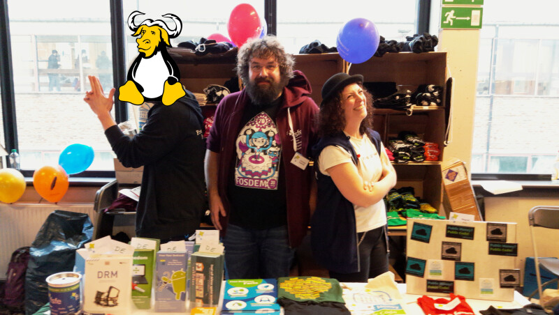 Volunteer who wants his face to be hidden, Christian Kalkhoff and Francesca Indorato at the FSFE booth at Fosdem