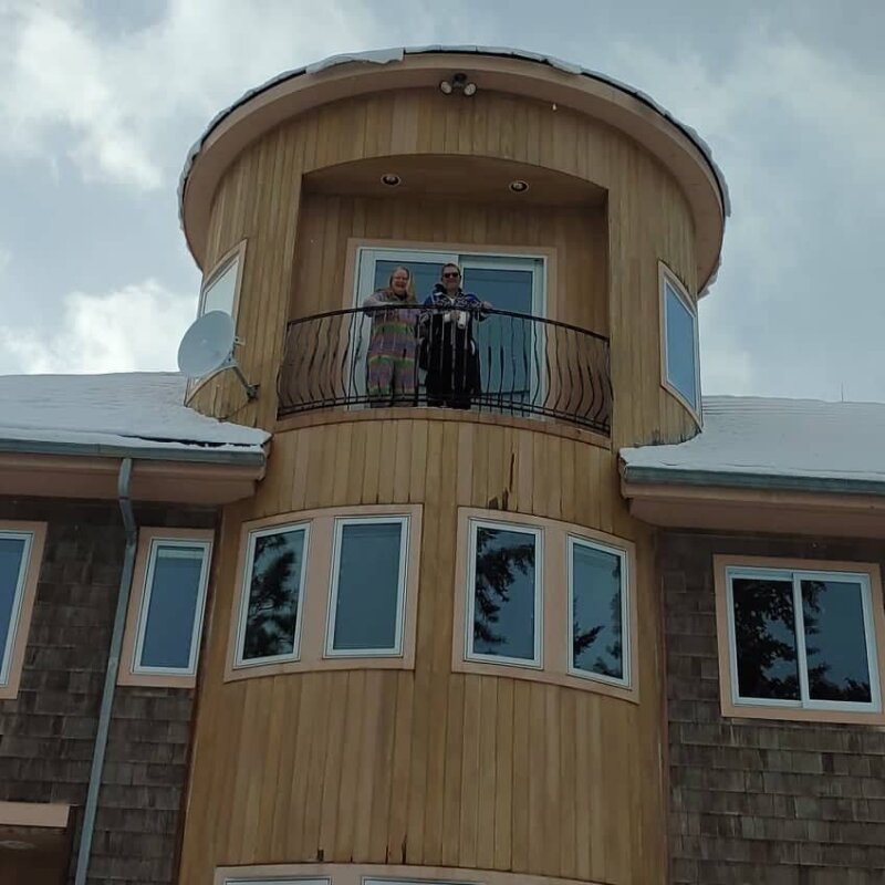 Rikke and Truls look down from their third-floor balcony.