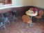 Photo of three nouveau leather covered bar stools next to a counter and a small round table with three butterfly chairs