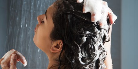 Woman washing her hair in shower