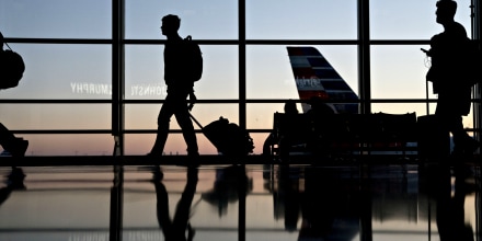 Image: Travelers walk through Ronald Reagan National Airport in Washington on Nov. 21, 2018.