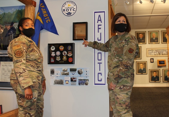 Staff Sgt. Tikeya Strong (left), Headquarters Air Force Junior ROTC, and Chief Master Sgt. of the Air Force JoAnne Bass discuss the new JROTC enlisted instructor legacy display at the Air Force Enlisted Heritage Research Institute, May 12, 2021, at Maxwell-Gunter Annex, Alabama. Strong spearheaded the display, which honors the dedication that AFJROTC enlisted instructors have by continuing to serve the nation past their 20 years on active duty. (U.S. Air Force photo by Christian Hodge)
