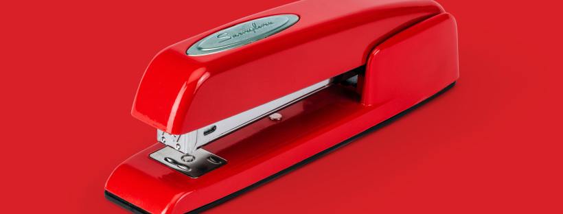 red swingline stapler on red background